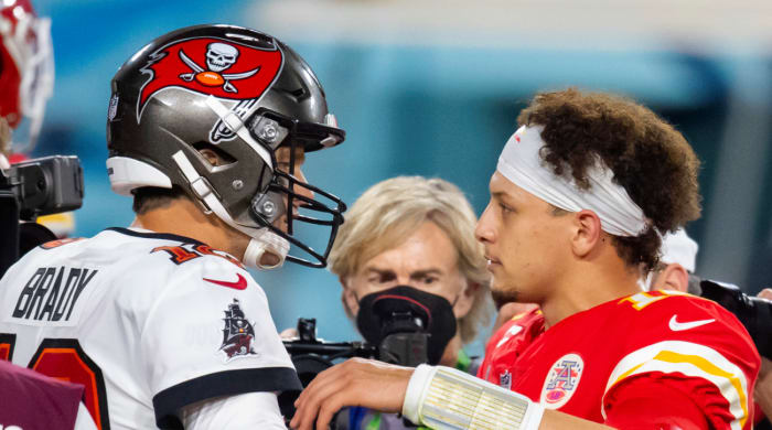 Tampa Bay Buccaneers quarterback Tom Brady (left) greets Kansas City Chiefs quarterback Patrick Mahomes following Super Bowl LV.
